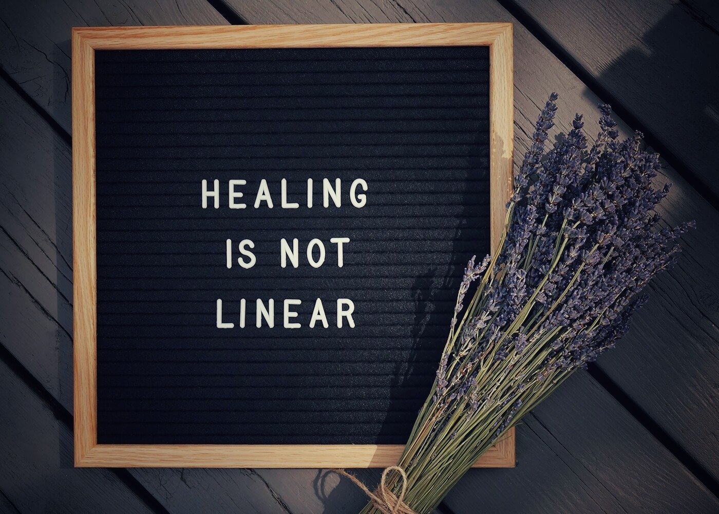 A message board that reads Healing Is Not Linear